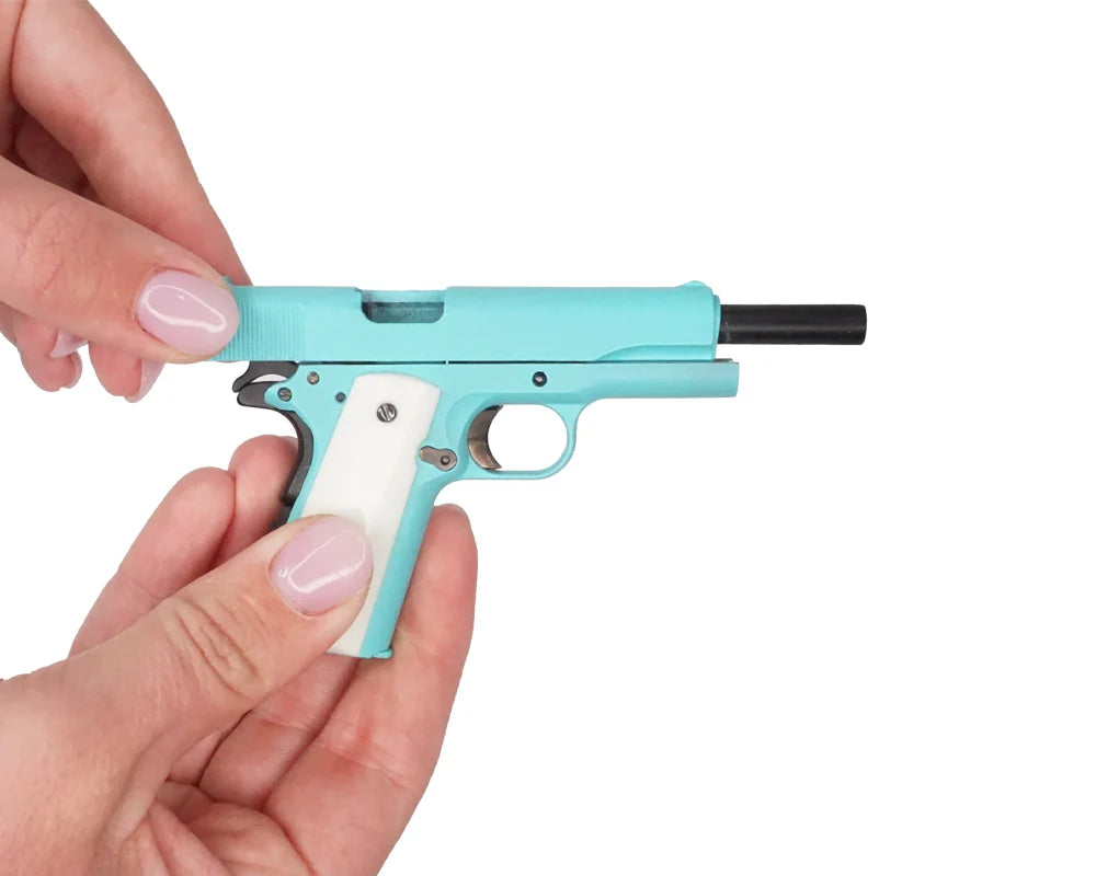 Bunny blue miniature 1911 model held in hand with slide open