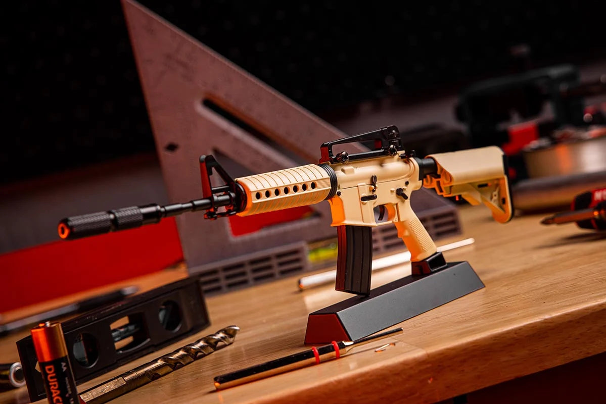 AR15 FDE Dust Off model with suppressor on display stand