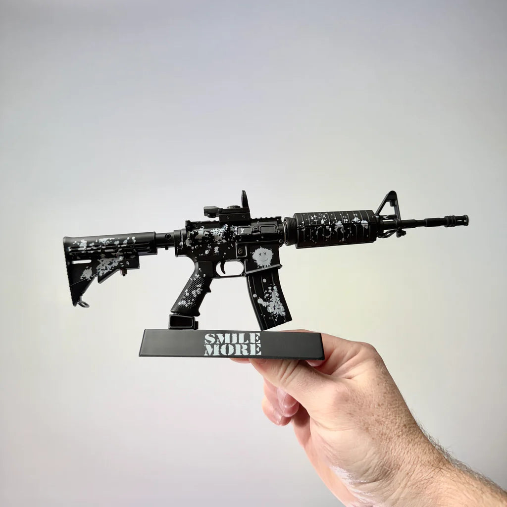 AR15 Smile More model and display stand held in hand