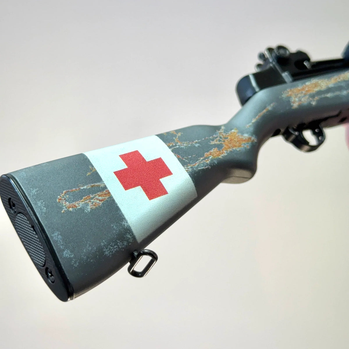 Medic M1 Garand model close-up of weathered stock and Red Cross marking