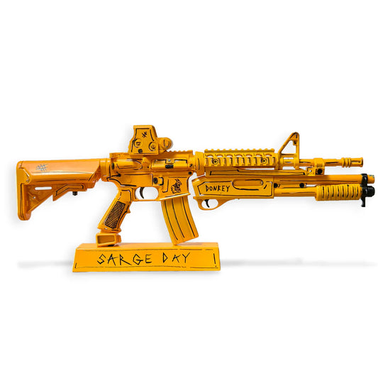 Sarge Day 2026 Payload gold AR15 miniature model on stand, white background