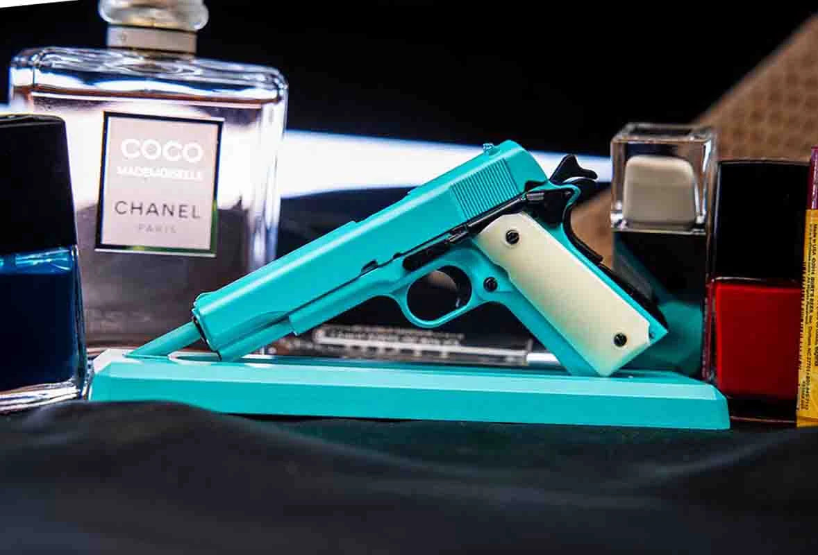 Bunny blue miniature 1911 model on stand in lifestyle scene