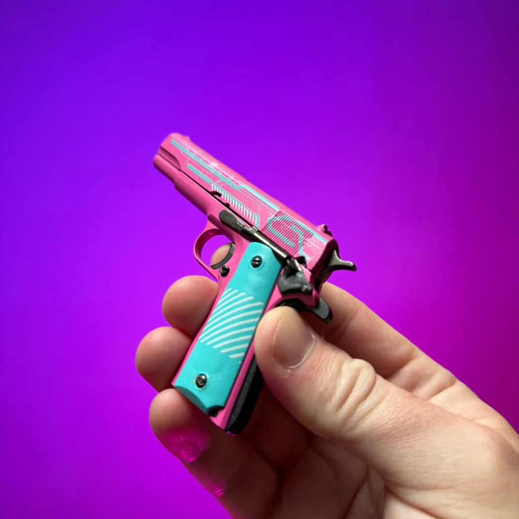 Close-up rear angle of pink and turquoise 1911 Edge Runner miniature model in hand